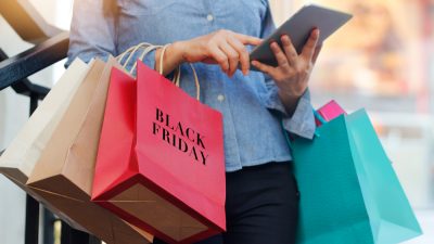 black friday shopping with a woman searching Facebook for sale info